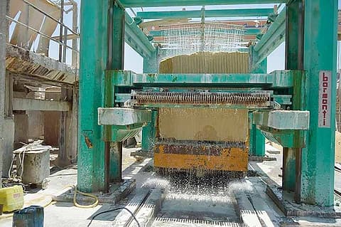 Automatic gang saw cutting a marble block at the Raya Stone factory