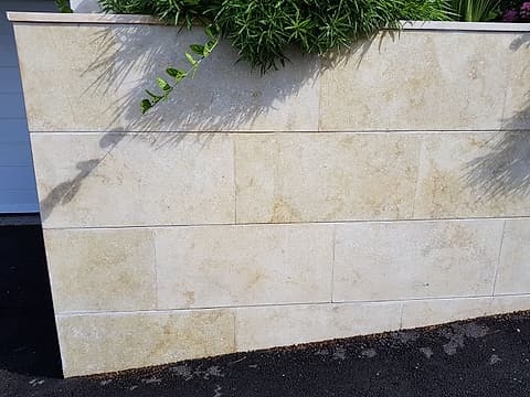 Villa garden wall clad in Sunny Minya limestone tiles